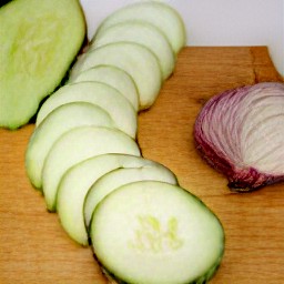 cucumbers, onion, and tomatoes that are sliced.