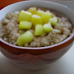 a bowl of apple oatmeal topped with diced apples.