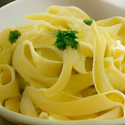 the pasta is transferred to a bowl and the tofu sauce is drizzled over it.