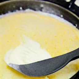 the egg mixture is cooked for 5 minutes and then the parmesan cheese, cheddar cheese, and mascarpone cheese mixture is added over it.