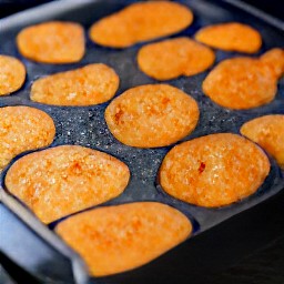 the sweet potato slices are placed on a baking sheet.