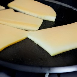 flipping cheese slices with a fish slice.
