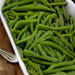 a dish of green beans, garlic, shallots, and olive oil that has been baked for 18 minutes.