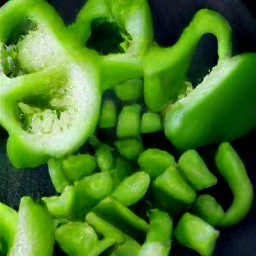 after peeling and chopping the onion, chop the green bell pepper and then peel and mince the garlic cloves.
