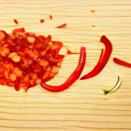 the output is a chopped red chili pepper with the seeds removed.