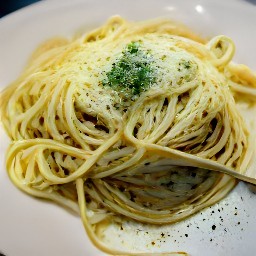 a bowl of spaghetti with olive oil, garlic mixture, and grated parmesan cheese on top.