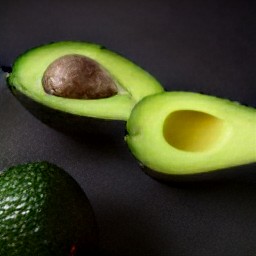 the tomatoes are chopped and the avocado is cut in half.