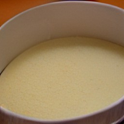 a bowl of eggs, milk, vanilla extract, and ground cinnamon mixed together, with bread dipped in it.
