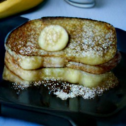 flipping the french toast with a fish slice.