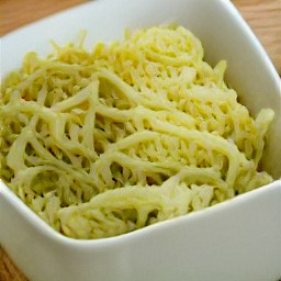 a bowl of egg noodles with poppy seeds mixed in.