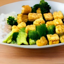 a meal consisting of tofu and broccoli in peanut sauce served over cooked white rice.