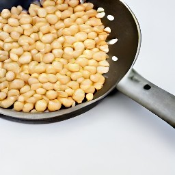 a pan of stir-fried pine nuts.