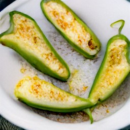 after 10 minutes have passed, the floured jalapeno peppers on a plate.