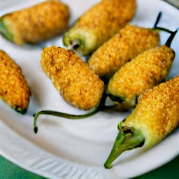 jalapeno poppers that have been drained on a paper towel and then transferred to a plate.
