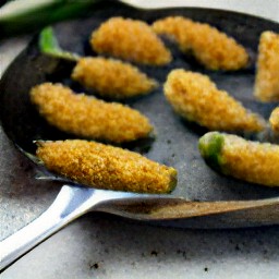 the breaded-stuffed jalapeno peppers are fried in vegetable oil for 2 minutes.