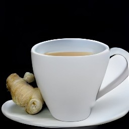 a mug cup full of strained liquid with granulated sugar and lemon juice mixed in.