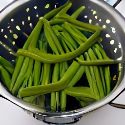 the green beans are drained in a colander.