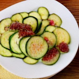 a plate of sauteed zucchini with sun-dried tomatoes.