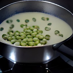 adding fava beans to the pan.