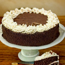 the buttercream frosting spread on the chocolate cake.