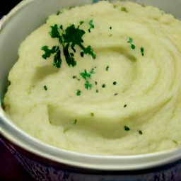 a bowl of mashed potatoes with chopped onions, crushed caraway seeds, chopped parsley, lemon juice, all-purpose flour, and whole milk.