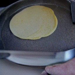 each pancake is flipped using a fish slice.