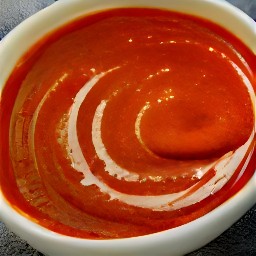 the enchilada sauce is transferred to a bowl.