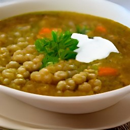 a bowl of barley lentil soup topped with yogurt mix.