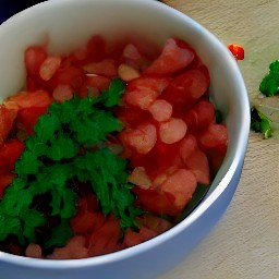 a bowl of tomato, onion, parsley, olive oil, and lemon juice salad.