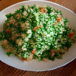 the bulgur is transferred to the salad bowl and stirred with a mixing spoon to get a tabbouleh salad.