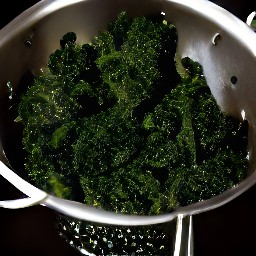 the cooked kale is drained in a colander.