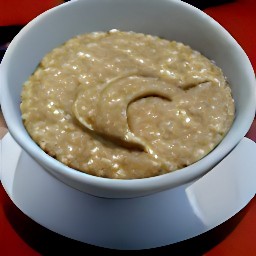 a bowl of rolled oats with peanut butter on top.