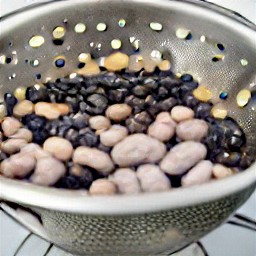 a colander full of rinsed and drained black beans, pinto beans, navy beans, cowpeas, green beans and corn.