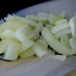 after peeling and chopping an onion, chop spinach and parsley.