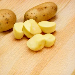 the russet potatoes are peeled using a peeler.