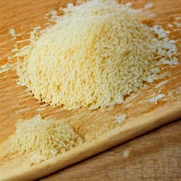 the parmesan cheese is shredded into small pieces.