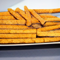 a platter of frozen jicamas cut side down, sprinkled with lime juice and chili powder.