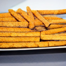 a platter of frozen jicamas cut side down, sprinkled with lime juice and chili powder.