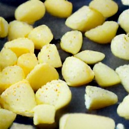 the potatoes are spread over the baking sheet.