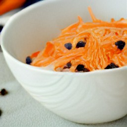the salad dressing is poured over the carrot mixture.