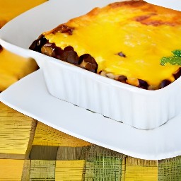 black beans and corn lasagna slices divided into plates.