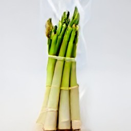 a bag of asparagus that has been coated in olive oil, salt, black pepper, and paprika.