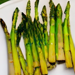 the asparagus is transferred from the grill to a platter.