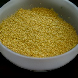 a bowl of cornflake crumbs, salt, black pepper, margarine, and roasted potatoes.