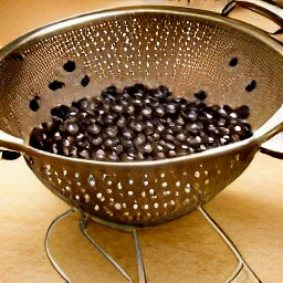 black beans and corn that have been rinsed and drained in a colander.