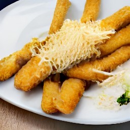 fried zucchini on a plate topped with grated parmesan cheese.