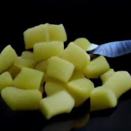 cut potatoes into 1-inch squares, peel and chop onions, then chop scallion.