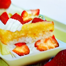 a pan of halved twinkies, strawberries, and whipping mixture.