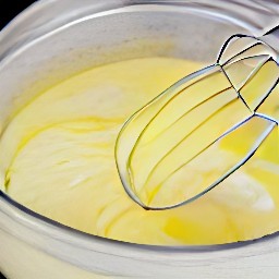 a bowl of beaten eggs with italian seasoning.