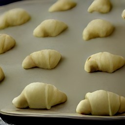 a cookie sheet with crescents on it.